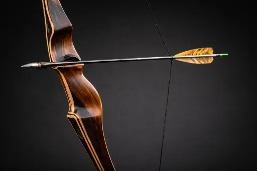 Traditional wood recurve bow with a contoured hand-shaped grip